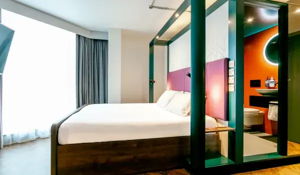 View of room with bed in centre 