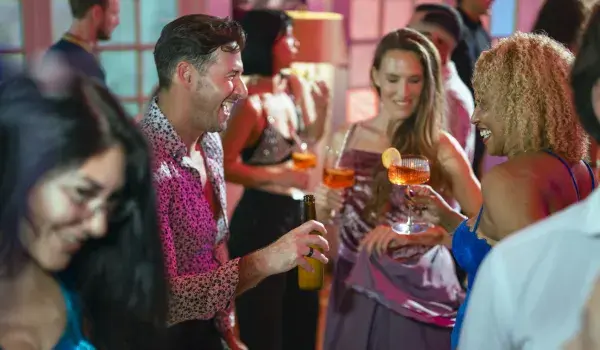 Group of people with drinks socialising