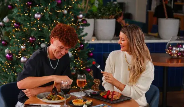 A couple enjoying food and drinks