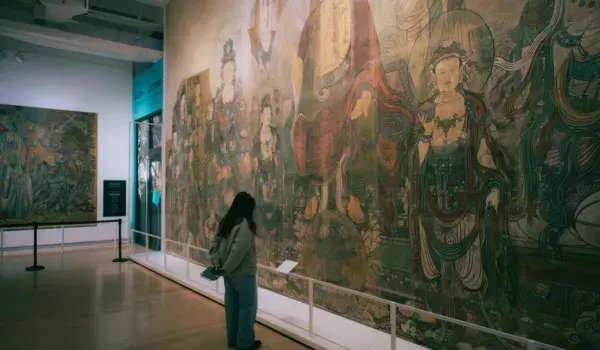 Woman standing in front of large artwork