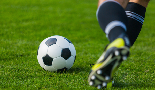 A man kicking a football