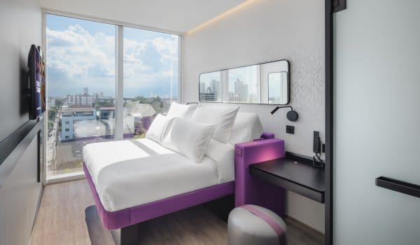 Double bed room with floor to ceiling window and desk