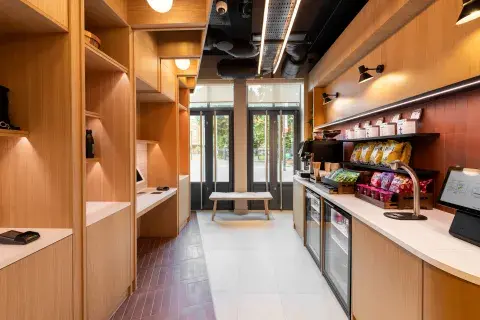 An airy self-service breakfast area with kiosks stacked with snacks and drinks