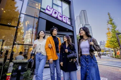 Four friends stand outside Tokyo Yotel