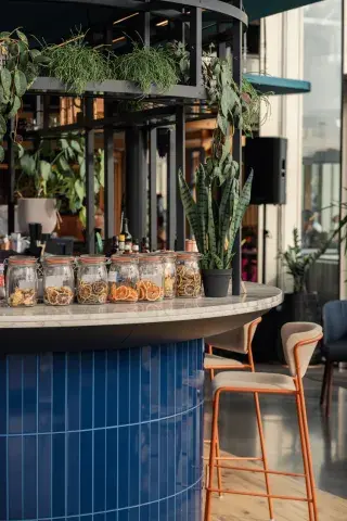 Blue bar stocked with spirits including gin, rum and whisky