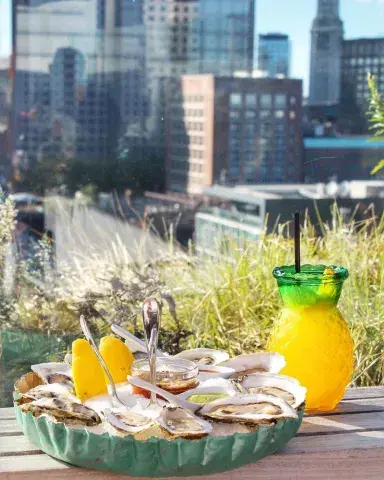 Fresh juice and oysters being served at a rooftop bar and restaurant 