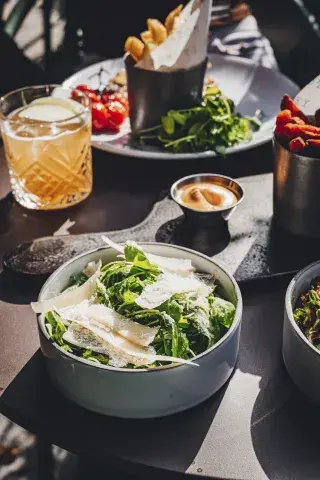 Salads, cocktails and dips spread across a table at a hotel restaurant